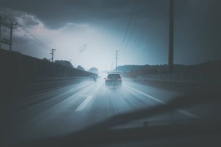 Cars on a highway at a rainy dusk (shallow DOF; color toned image)の写真素材