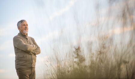 Portrait of handsome senior man in the autumn outdoors. Active senioor enjoying his retirement in the  natureの写真素材