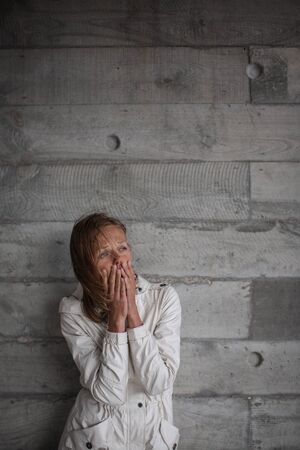 Depressed/anxious young woman suffering from solitude, isolation. Corona virus outbreak situation. Self quarantine at home prevention COVID-19 conceptの写真素材