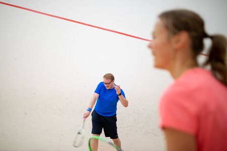 Squash players in action on a squash court (motion blurred image; color toned image)の写真素材