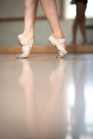 Legs and slippers of classical ballet dancers rehearsingの写真素材