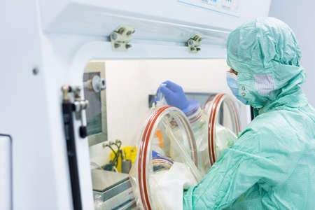 Virus antidote being prepared in a biochem lab with extremely strict precautionary measures (shallow DOF; color toned image)の写真素材