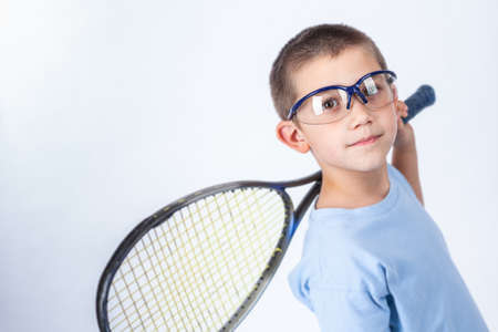 Young squash player with protective glasses and squash racketの写真素材