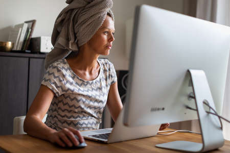 Home office/Remote work series - Pretty, young woman working at her computer from home