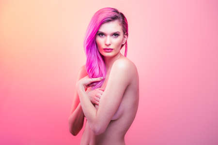 Beautiful nude blonde young woman posing in studioの写真素材