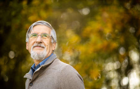 Portrait of a senior man outdoors, against the sky - optimism, good health, happyness radiates of the man's face, expressionの写真素材
