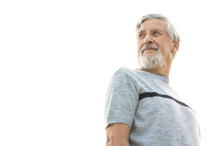 Happy senior man outdoors against the sky on a warm summer dayの写真素材