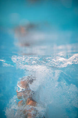 Cute little boy in a swimming poolの写真素材
