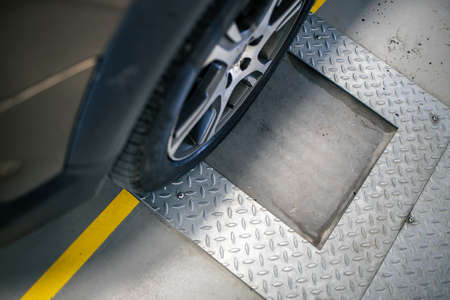 Car mechanic changind tires of a car in a repair shop/car garage (shallow DOF/color toned image)