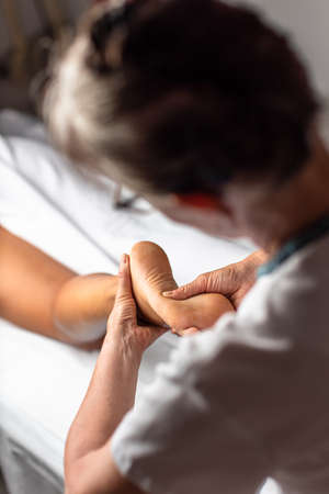 Massage procedure - neck and whole body massage by a female masseuse. doing massaging using oil.の写真素材