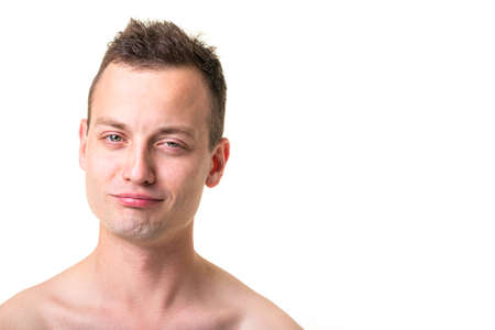 Portrait of a handsome young man on white background, making funny facesの写真素材