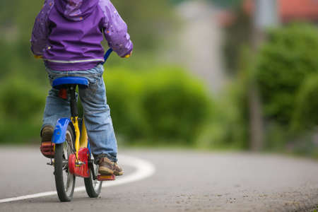Little cyclist on a little bike (shallow DOF)の写真素材