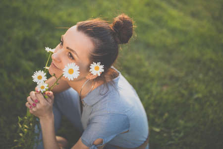 Pretty, young woman in a lovely park, enjoying some free time on a weekend (color toned image)の写真素材