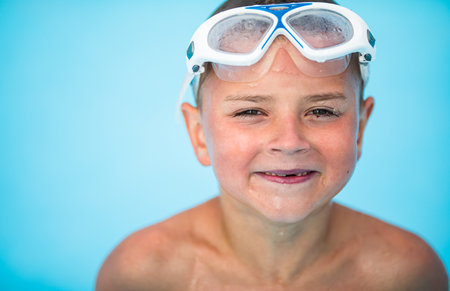 Cute little boy in a swimming poolの写真素材