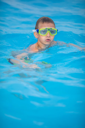 Cute little boy in a swimming poolの写真素材