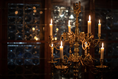 Splendid chandelier with lit candles in a beautiful room of an old mansionの写真素材