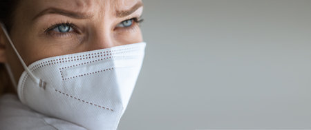 Young woman wearing a face mask during  and flu outbreak. Virus and illness protection, home quarantine.の写真素材