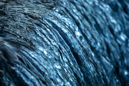 Water cocept - river water flowing with light reflecting of its surfaceの写真素材