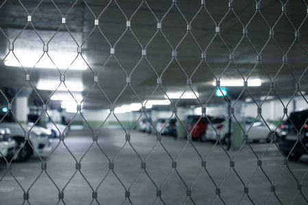 Underground parking. Cars parked in a garage with no people. Many cars in parking garage interior. Underground parking with cars (color toned image)の写真素材