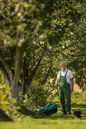 Senior gardenr gardening in his permaculture gardenの写真素材