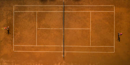 Tennis players on the court. Wide angle view from above with plenty of copyspaceの写真素材