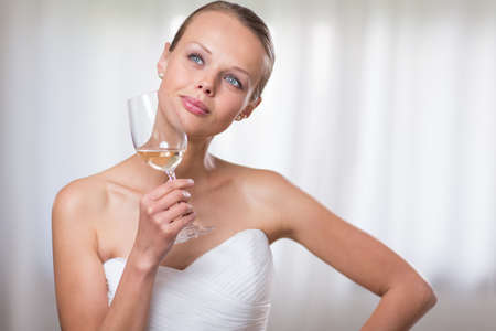 Lovely bride with a glass of white wineの写真素材