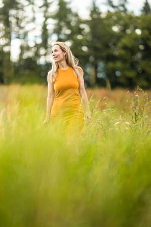 Portrait of a relaxed middle aged woman outdoors, looking happy, enjoying the lifeの写真素材
