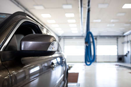 Car in a garage undergoing regular checks (shallow DOF / color toned image)の写真素材