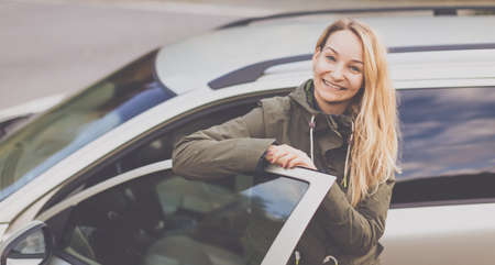 Pretty young woman by her car ready for her daily commute to work
