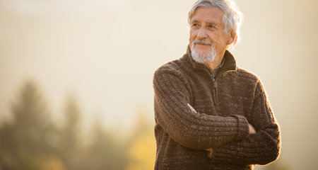 Happy senior man enjoying a lovele autumn day outdoorsの写真素材