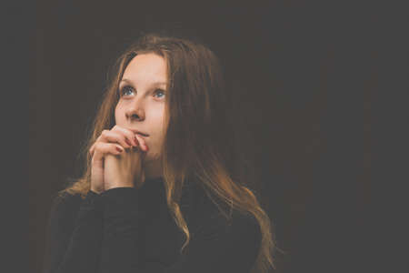 Young woman praying  to God. Christian life crisis prayer to god.の写真素材