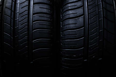 Tire change - wheel balancing or repair and change car tire at auto service garage or workshop by mechanicの写真素材