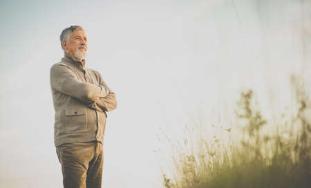 Portrait of handsome senior man in the autumn outdoors. Active senior enjoying his retirement in the natureの写真素材