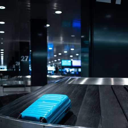 Young woman with her luggage at an international airport, before going through the check-in and the security check before her flightの写真素材
