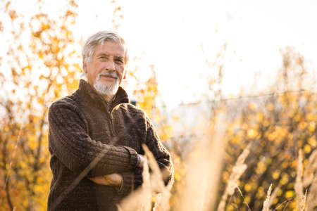 Happy senior man enjoying a lovele autumn day outdoors