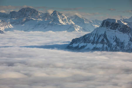 Splendid apline scenery. High mountains with fog and lovely evening light.の写真素材