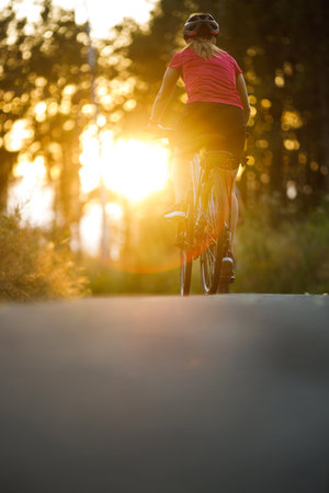 Happy woman riding bicycles outside, healthy lifestyle fun concept, taking a break admiring the viewの写真素材
