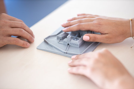 People with impaired vision using tactile maps, 3D models of town centres, landmarks, streetsの写真素材