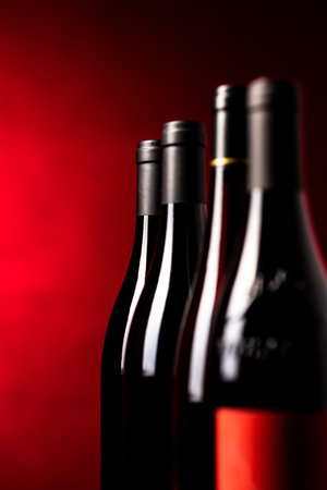 Bottles of quality red wines shot with shallow DOF; color toned imageの写真素材