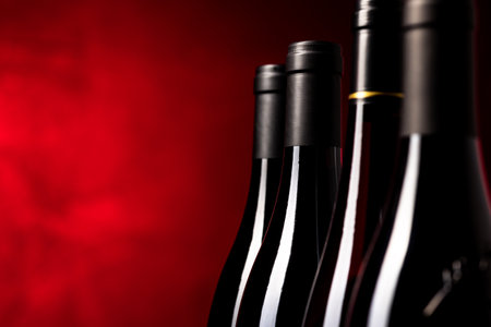 Bottles of quality red wines shot with shallow DOF; color toned imageの写真素材