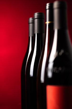 Bottles of quality red wines shot with shallow DOF; color toned imageの写真素材