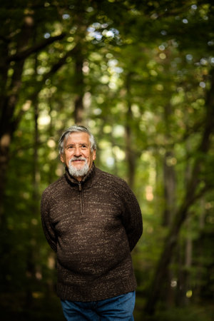 Elderly Caucasian male walking outdoors on an autumn, fall dayの写真素材