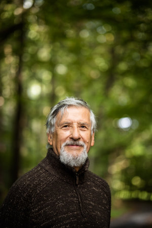 Elderly Caucasian male walking outdoors on an autumn, fall dayの写真素材