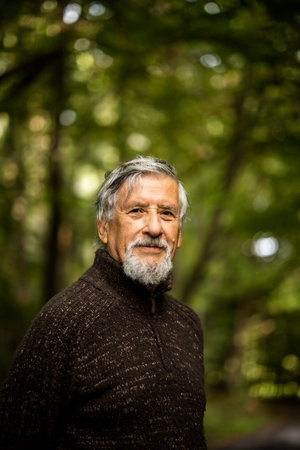 Elderly Caucasian male walking outdoors on an autumn, fall dayの写真素材