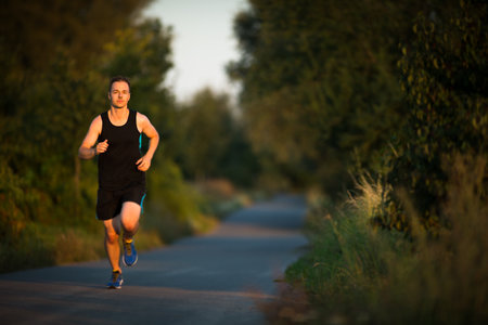 Shot of a young male athlete training. Getting his daily dose of mileage, to stay fit and lean.の写真素材