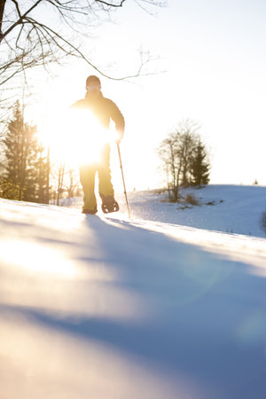Snowshoeing in winter in deep snow. Walking in the snow. Hiking in the mountains in winter.の写真素材