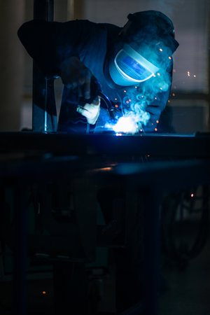 Man working on iron with grinder. Man at work. Sparkles and fire from grinder cutting. Grinder....