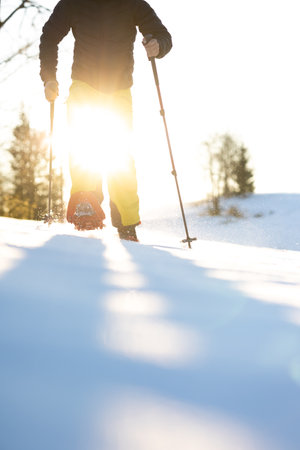Snowshoeing in winter in deep snow. Walking in the snow. Hiking in the mountains in winter.の写真素材