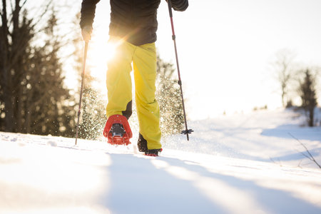 Snowshoeing in winter in deep snow. Walking in the snow. Hiking in the mountains in winter.の写真素材