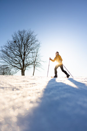 Snowshoeing in winter in deep snow. Walking in the snow. Hiking in the mountains in winter.の写真素材